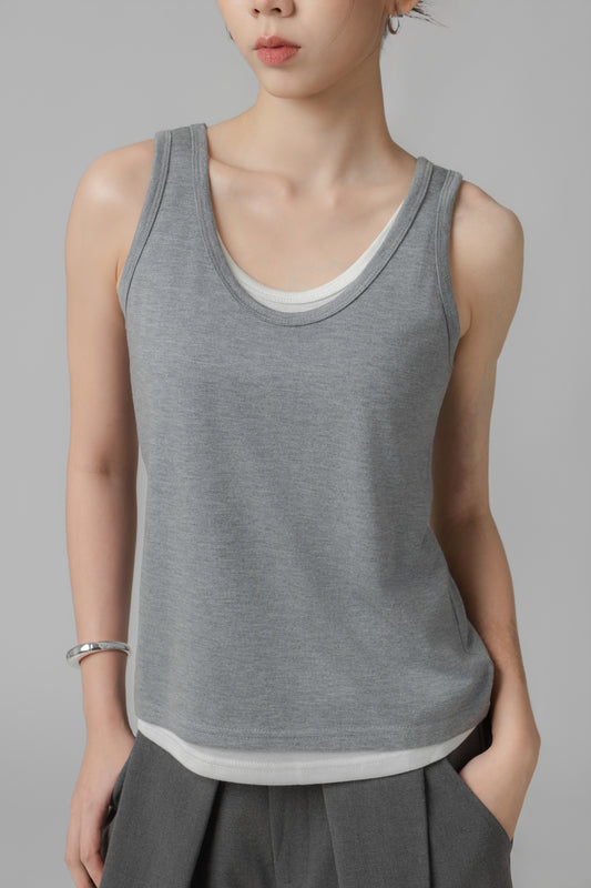 Woman wearing a grey two-layer tank top and grey wide-leg pants