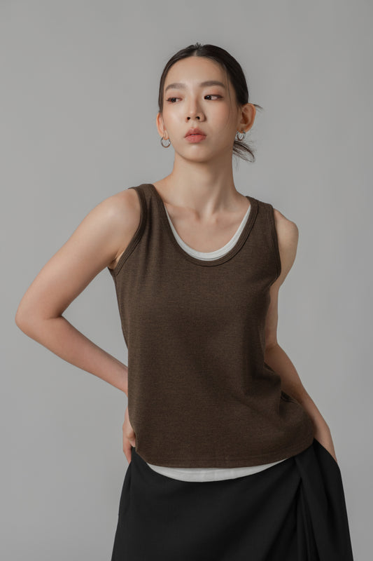 Woman wearing a dark brown two-layer tank top and black wide-leg pants